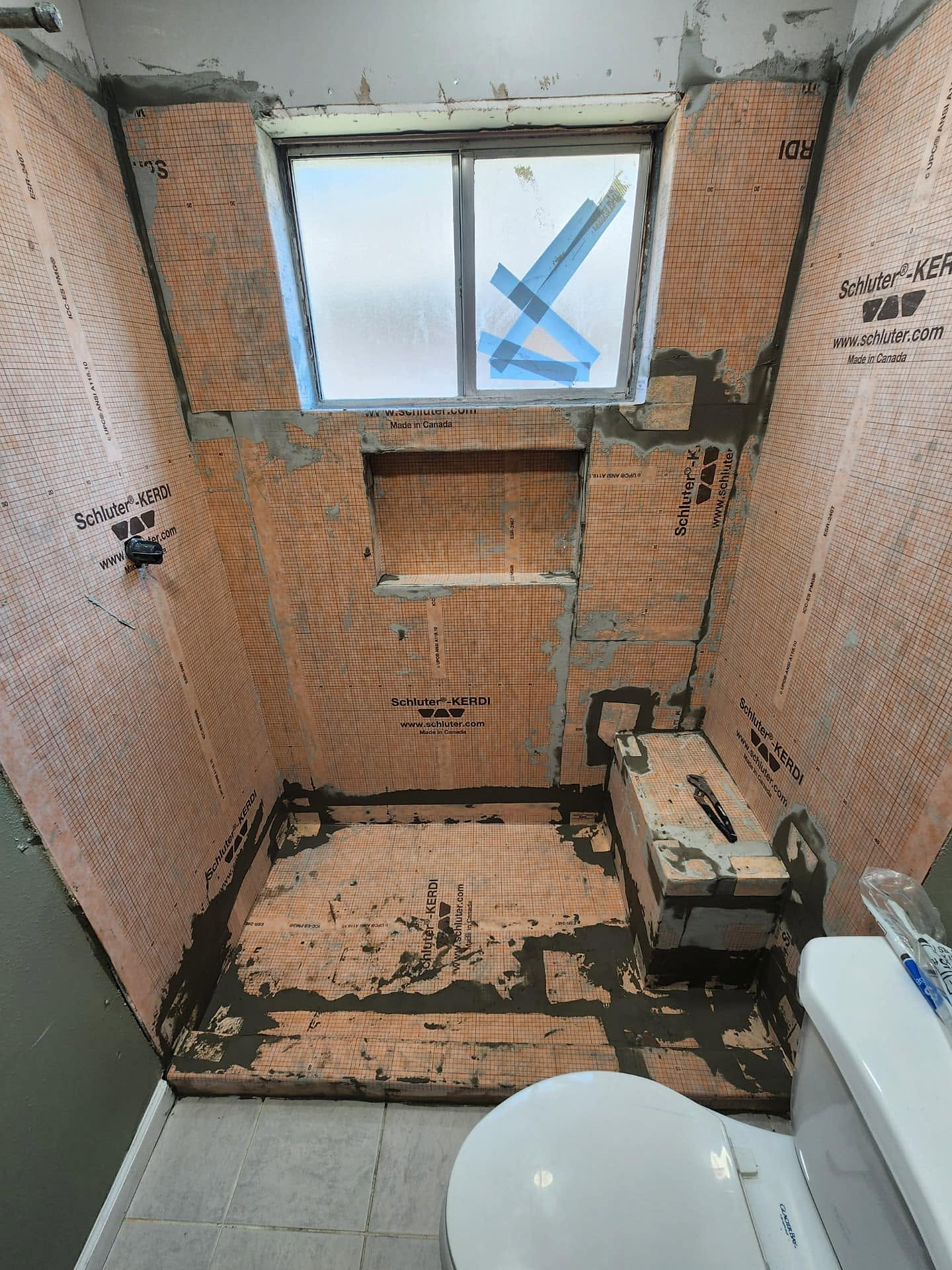 A shower rebuilt with KERDI waterproofing and a new bench