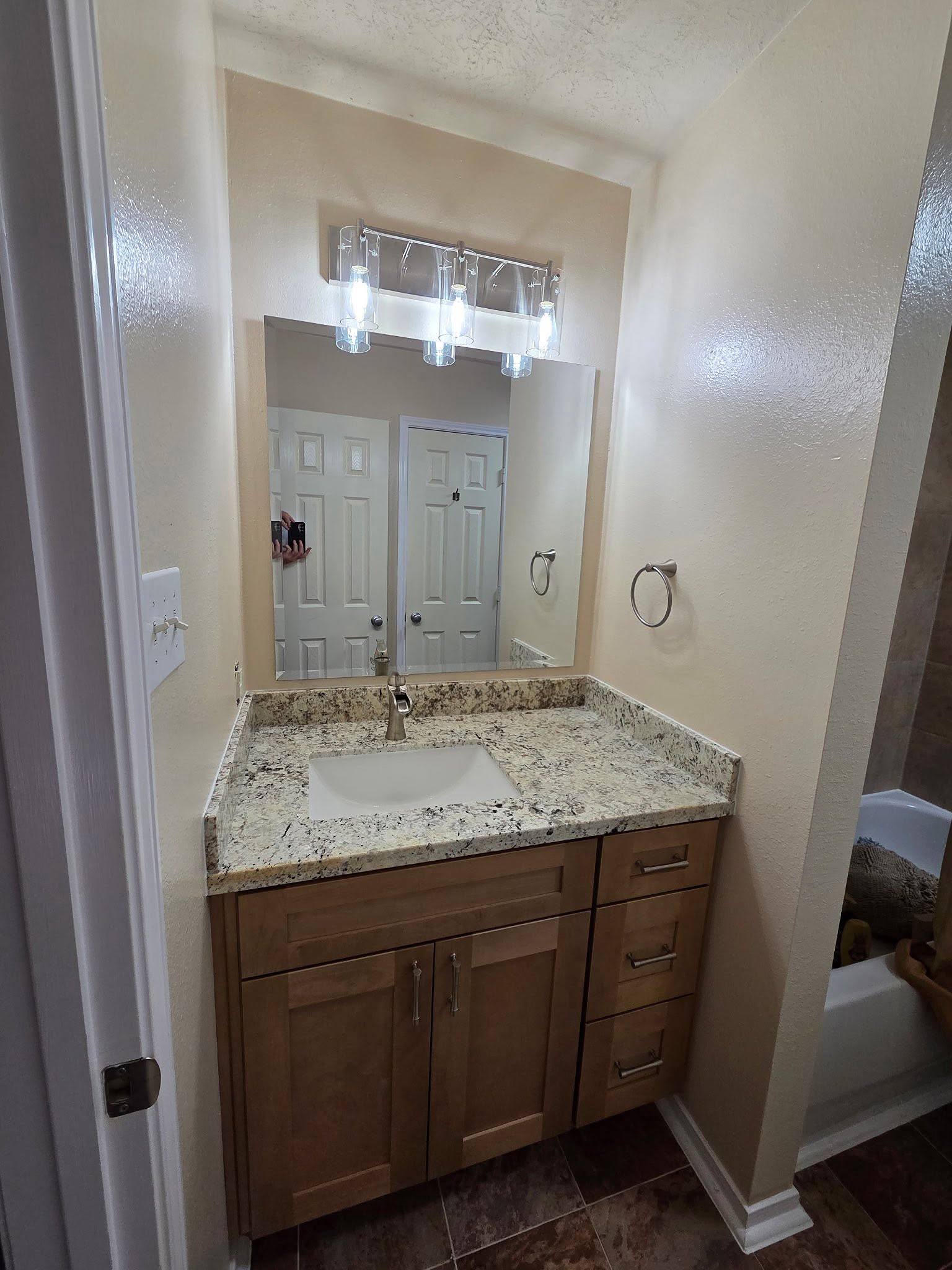 The same vanity nook rebuilt with wood cabinets and a granite top by Reeder
