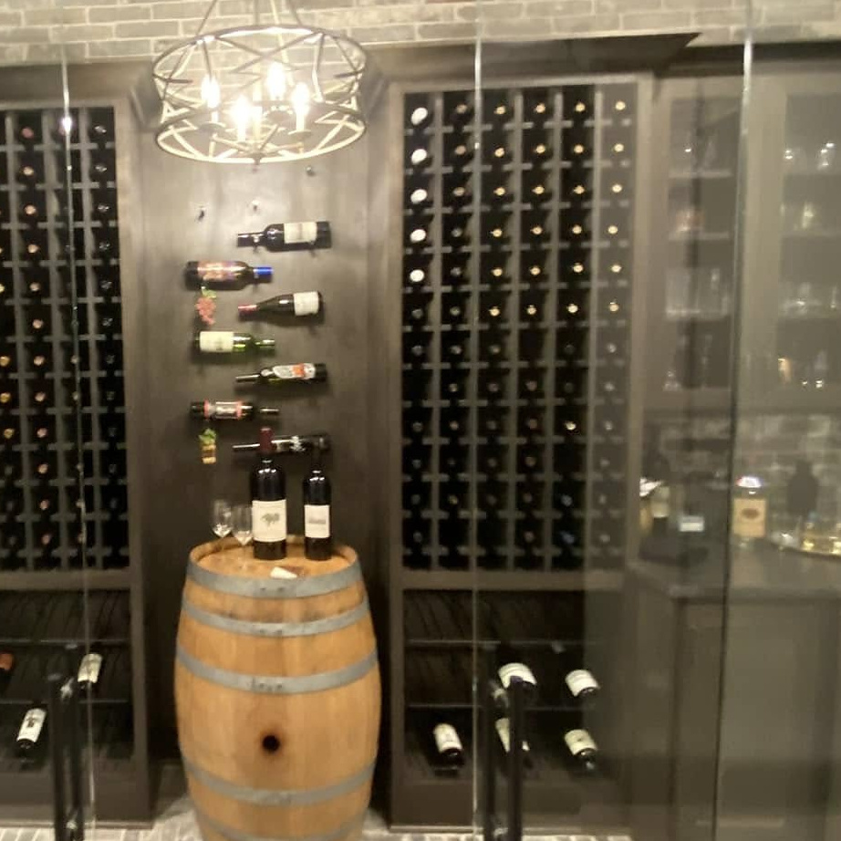 Wine racks and glass cabinets inside a custom Reeder wine cellar